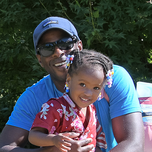 Father and child in garden setting